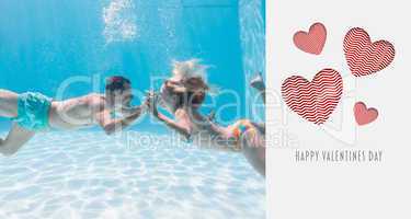 Composite image of cute couple kissing underwater in the swimmin