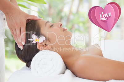 Composite image of beautiful brunette enjoying a head massage