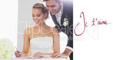 Composite image of happy young couple signing wedding register