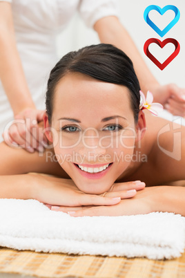 Composite image of peaceful brunette enjoying a herbal compress