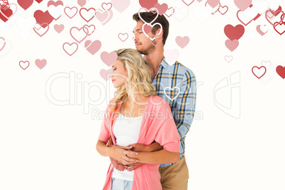 Composite image of attractive young couple embracing and smiling