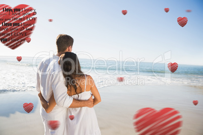 Composite image of content couple looking at the sea