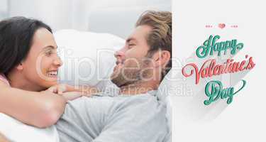 Composite image of cheerful couple awaking and looking at each o