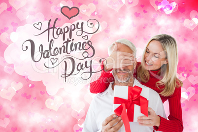 Composite image of loving couple with gift