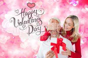 Composite image of loving couple with gift