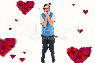 Composite image of geeky hipster looking nervously at camera