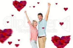 Composite image of attractive couple smiling and cheering