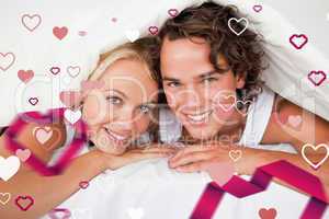 Composite image of couple under a duvet