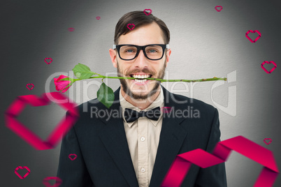 Composite image of geeky hipster holding rose between teeth