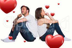 Composite image of young couple sitting on floor