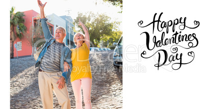 Composite image of happy mature couple cheering in the city