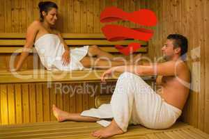 Composite image of happy couple relaxing in a sauna and chatting