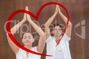 Composite image of peaceful couple in white doing yoga together
