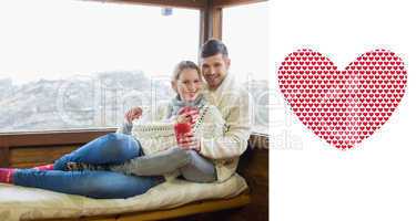 Composite image of couple in winter wear with coffee cups agains