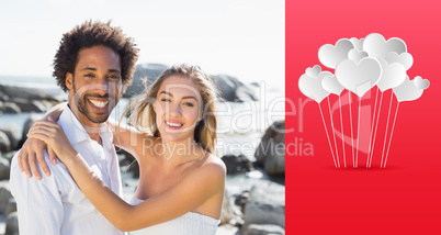 Composite image of gorgeous couple embracing by the coast