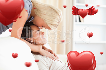 Composite image of woman kissing her fiance on the forehead