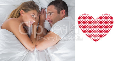 Composite image of cute couple lying and looking at each other i