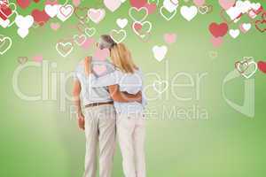 Composite image of happy couple standing and looking