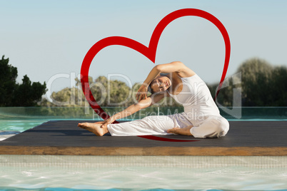 Composite image of peaceful brunette in janu sirsasana yoga pose