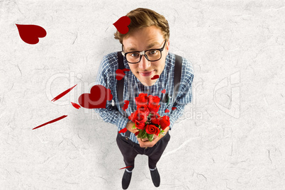 Composite image of geeky hipster holding a bunch of roses