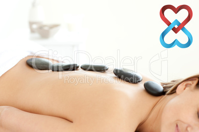 Composite image of attractive woman receiving a spa treatment