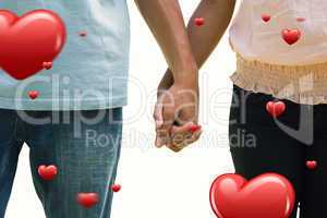 Composite image of young couple holding hands in the park