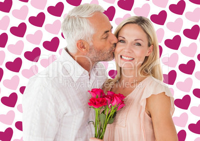 Composite image of affectionate man kissing his wife on the chee