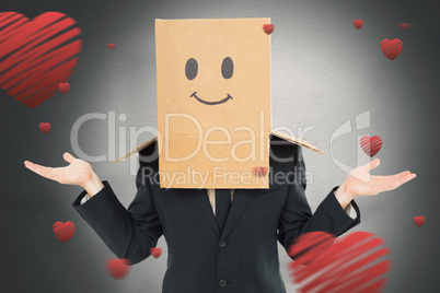 Composite image of businessman shrugging with box on head