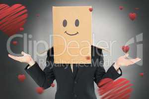 Composite image of businessman shrugging with box on head