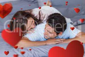 Composite image of couple having fun on the bed