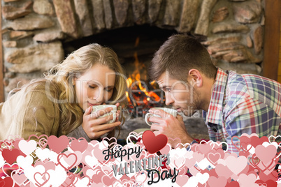 Composite image of romantic couple drinking tea in front of lit