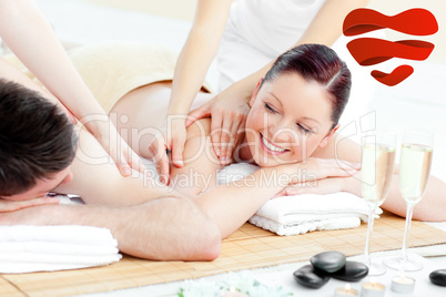 Composite image of positive young couple enjoying a back massage