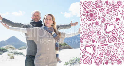 Composite image of carefree couple standing on the beach in warm