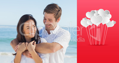 Composite image of cheerful couple relaxing on the beach during