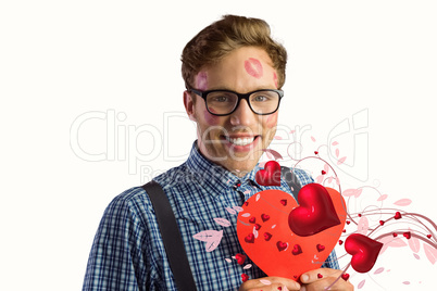 Composite image of geeky hipster covered in kisses