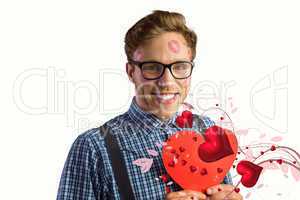 Composite image of geeky hipster covered in kisses