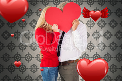 Composite image of handsome man getting a heart card form wife