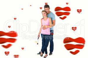 Composite image of young couple painting with roller