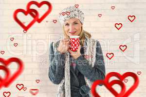 Composite image of smiling woman in winter fashion looking at ca