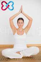 Composite image of peaceful brunette sitting and meditating in l