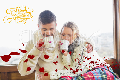 Composite image of loving couple in winter wear drinking coffee