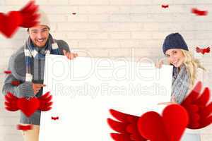 Composite image of attractive couple in winter fashion showing p