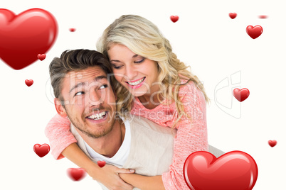 Composite image of handsome man giving piggy back to his girlfri