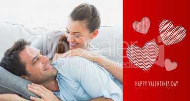 Composite image of cheerful couple relaxing on their sofa smilin