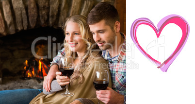 Composite image of couple with wineglasses in front of lit firep