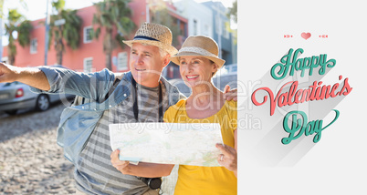 Composite image of happy tourist couple using map in the city