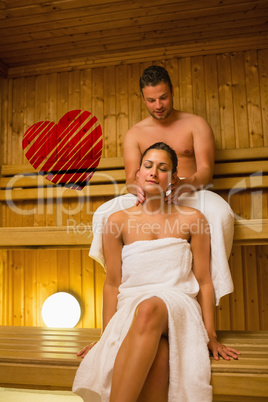 Composite image of man giving his girlfriend a neck massage in s