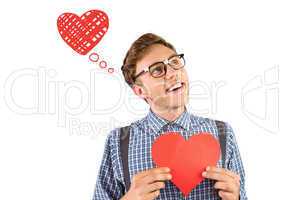 Composite image of geeky hipster holding a heart card