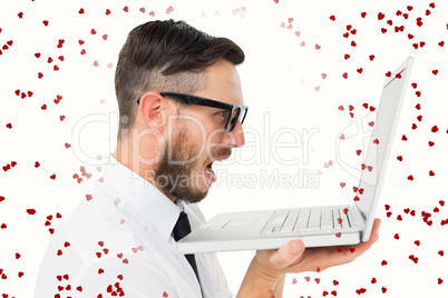 Composite image of geeky frustrated businessman looking at his l