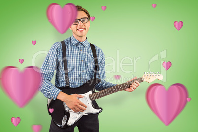 Composite image of geeky hipster playing the guitar